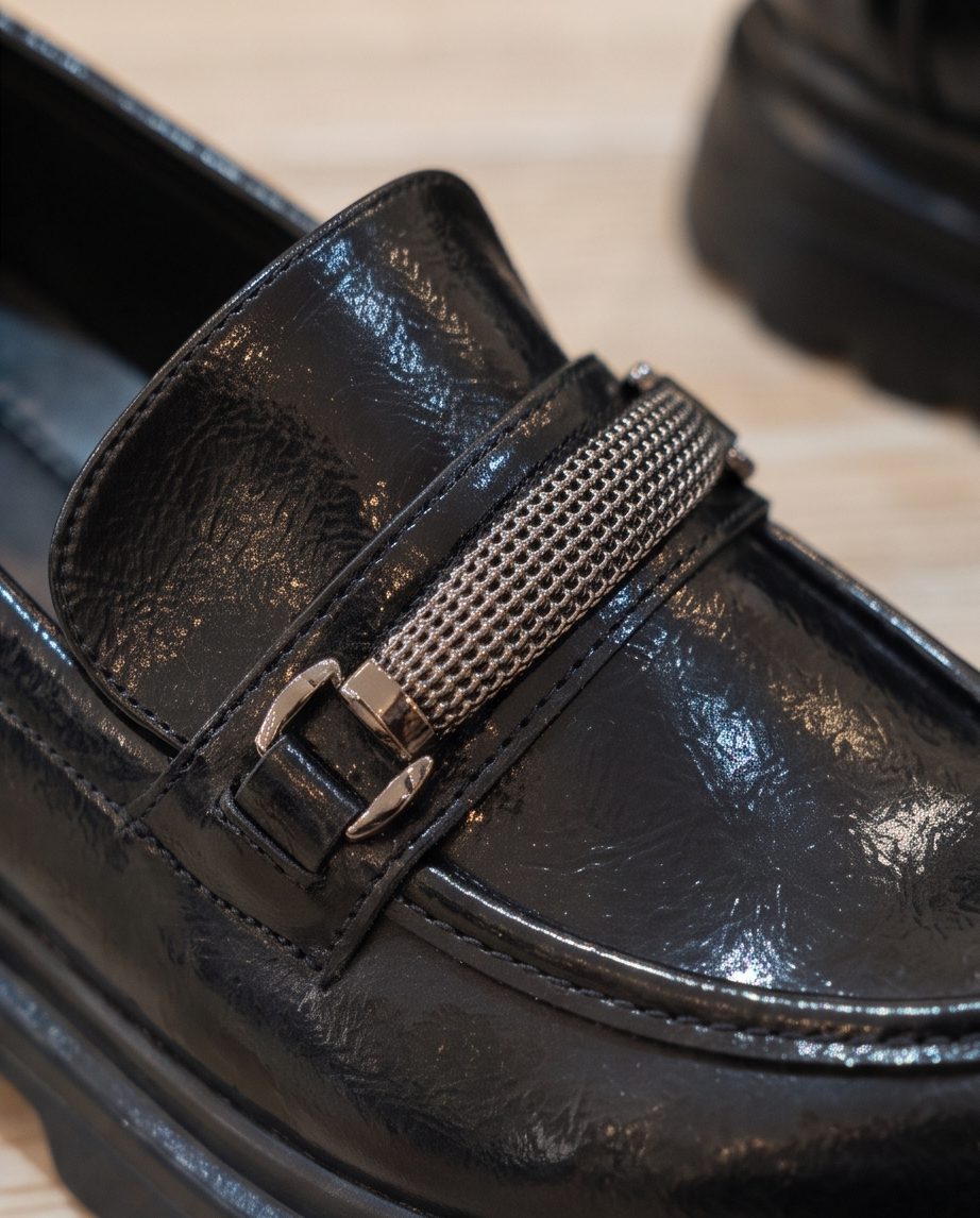 Black Monroe Lace loafers with sleek leather design and detailed stitching, perfect for casual or formal wear.