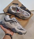 New Balance 9060 sneakers with Monroe Lace design, featuring a sleek grey and white athletic shoe with modern styling.