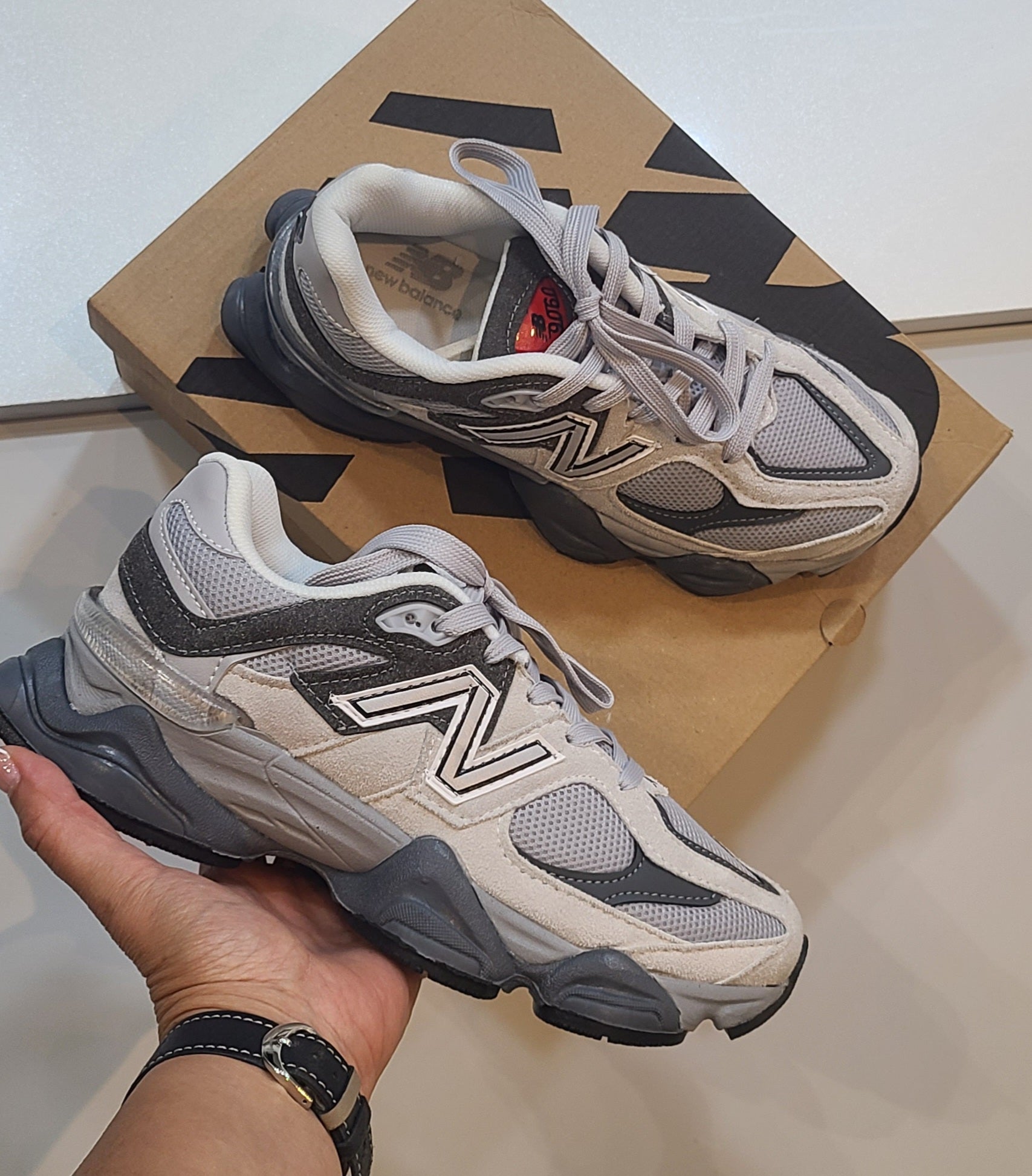 New Balance 9060 sneakers with Monroe Lace design, featuring a sleek grey and white athletic shoe with modern styling.