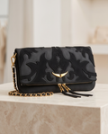 Small Monroe Lace designer's bag with elegant leather straps and compact shape, ideal for stylish everyday use.