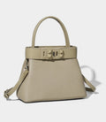 Medium size Monroe Lace handbag showing structured design, beige color, and top handles with decorative lace accents.