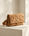 Medium-sized designer's bag by Monroe Lace, featuring a sleek leather exterior and elegant handle design.