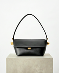 Small elegant handbag from Monroe Lace featuring a sleek design with top handles and subtle details.