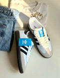 Adidas Samba sneakers with Monroe Lace design, featuring classic black and white colorway and detailed stitching.