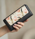Monroe Lace floral flap wallet with vibrant flower pattern and leather accents, showcasing its stylish design and compact size.