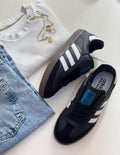Adidas Samba sneakers by Monroe Lace, featuring classic black and white design with leather and suede upper details