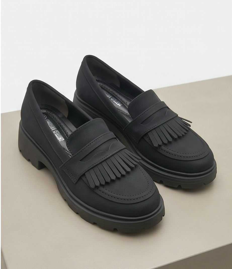 Black fringed loafers by Monroe Lace featuring stylish fringe detailing and classic slip-on design.